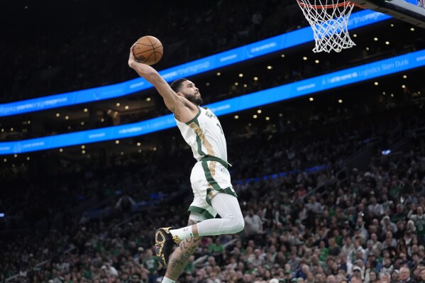 Boston Celtics forward Jayson Tatum (0) dunks to score in the second half of an NBA basketball game against the Memphis Grizzlies, Sunday, Feb. 4, 2024, in Boston. (AP Photo/Steven Senne)