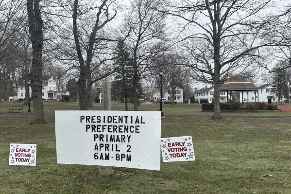 FILE - Election signs are seen on the town green in Colchester, Conn., March 27, 2024. (AP Photo/Susan Haigh)