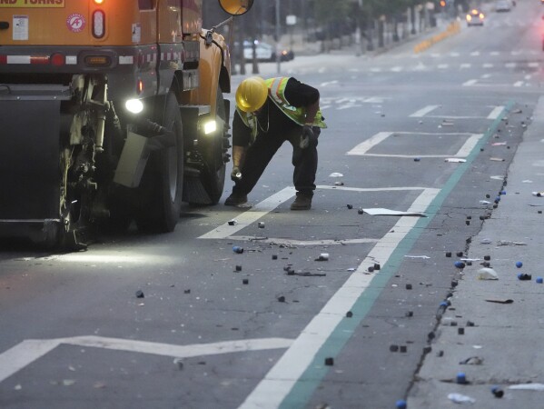 Cleanup continues after a night of protests in downtown Los Angeles, Monday, June 9, 2025. (AP Photo/Damian Dovarganes)