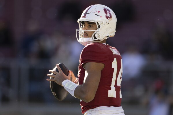Stanford quarterback Ashton Daniels (14) holds the ball during the second half of an NCAA college football game against Louisville in Stanford, Calif., Saturday, Nov. 16, 2024. (AP Photo/Benjamin Fanjoy)