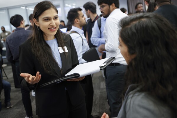 Emory University student Priyanka Somani, left, speaks with a representative of Sociallyn, a social media agency during the Startup Student Connection job fair, Wednesday, March 29, 2023, in Atlanta. For the thousands of workers who'd never experienced upheaval in the tech sector, the recent mass layoffs at companies like Google, Microsoft, Amazon and Meta came as a shock. Now they are being courted by long-established employers whose names aren't typically synonymous with tech work, including hotel chains, retailers, investment firms, railroad companies and even the Internal Revenue Service. (AP Photo/Alex Slitz)