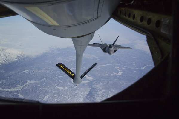 FILE - In this photo provided by the Alaska National Guard, an F-22 Raptor jet fighter prepares to hook up to an Alaska Air National Guard KC-135 Stratotanker, from the 168th Air Refueling Wing, to conduct in-air refueling over the Joint Pacific Alaska Range Complex during their fighter/bomber exercises May 1, 2014. The Air National Guard has delayed personnel changes in Alaska until Sept. 2025, that could have threatened national security and civilian rescue missions. (Lt. Bernie Kale/Alaska National Guard via AP, File)