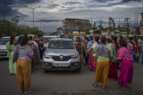 Members of Meira Paibis, powerful vigilante group of Hindu majority Meitei women, block traffic as they check vehicles for the presence of members from rival Christian tribal Kuki community, in Imphal, capital of the northeastern Indian state of Manipur, Monday, June 19, 2023. Manipur is caught in a deadly conflict between the two ethnic communities that have armed themselves and launched brutal attacks against one another. At least 120 people have been killed since May. (AP Photo/Altaf Qadri)