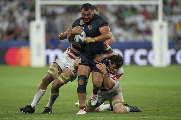 England's Ellis Genge charges with the ball during the Rugby World Cup Pool D match between England and Japan in the Stade de Nice, in Nice, France Sunday, Sept. 17, 2023. (AP Photo/Daniel Cole)