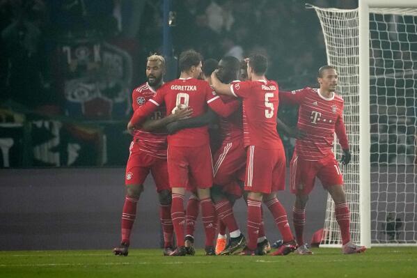 Bayern's Kingsley Coman celebrates with teammates after scoring his side's opening goal during the Champions League round of 16 first leg soccer match between Paris Saint Germain and Bayern Munich, at the Parc des Princes stadium, in Paris, France, Tuesday, Feb. 14, 2023. (AP Photo/Christophe Ena)