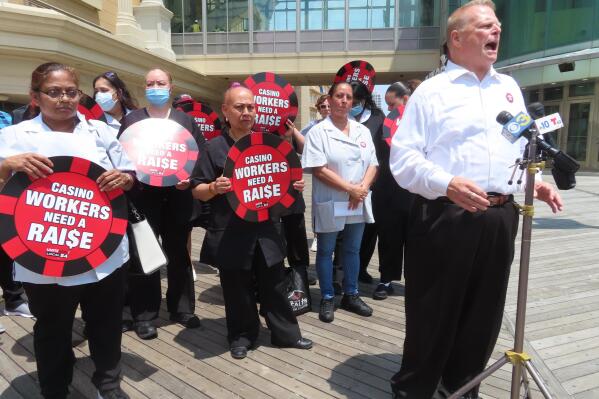 Bob McDevitt, left, president of Local 54 of the Unite here union, speaks at a press conference on the Atlantic City, N.J., Boardwalk on Wednesday, June 8, 2022, at which he announced the union filed a complaint with New Jersey officials accusing four casinos of failing to clean each occupied hotel room each day as required by an executive order from the governor. (AP Photo/Wayne Parry)