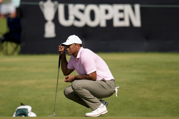 Tiger Woods lines up a putt on the 16th hole during the first round of the U.S. Open golf tournament Thursday, June 13, 2024, in Pinehurst, N.C. (AP Photo/Mike Stewart)