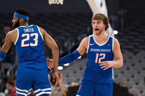 Boise State guard Max Rice (12) greets forward Naje Smith (23) after Rice hit a 3-pointer during the second half of the team's NCAA college basketball game against Texas A&M in Fort Worth, Texas, Saturday, Dec. 3, 2022. (AP Photo/Emil Lippe)