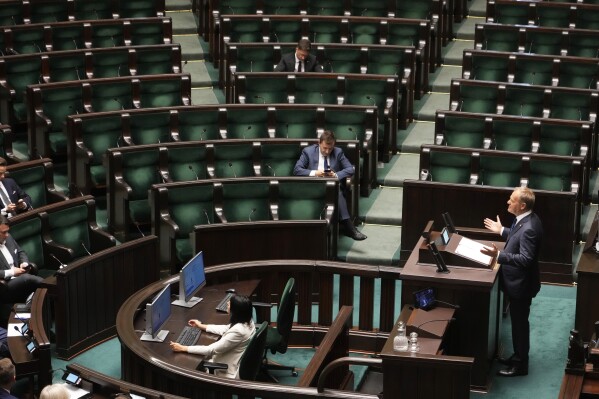 Poland's Prime Minister Donald Tusk addresses the Polish parliament on Wednesday, June 11, 2025, in Warsaw, Poland. (AP Photo/Czarek Sokolowski)