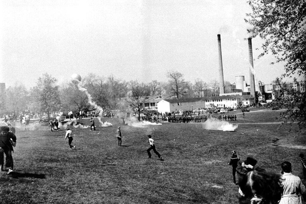 Ohio National Guardsmen throw tear gas at students across the campus lawn at Kent State University during an anti-Vietnam War demonstration at the university on May 4, 1970.  The Guard killed four students and wounded nine.  (AP Photo)