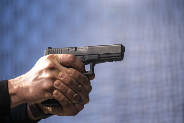 FILE - A semi-automatic Glock pistol is fired at the Bureau of Alcohol, Tobacco, Firearms, and Explosives (ATF), National Services Center, March 2, 2023, in Martinsburg, W.Va. The city of Chicago sued Glock Inc. on Tuesday, March 19, 2024, alleging the handgun manufacturer is facilitating the proliferation of illegal machine guns that can fire as many as 1,200 rounds per minute on the streets of the city. (AP Photo/Alex Brandon, File)