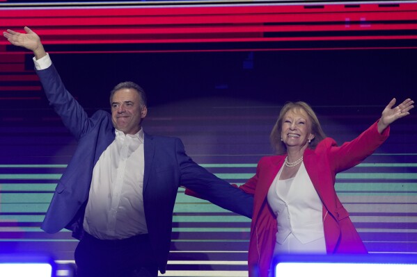 Yamandu Orsi, candidate for the Broad Front (Frente Amplio) and running mate Carolina Cosse, right, celebrate after polls closed in the presidential run-off election in Montevideo, Uruguay, Sunday, Nov. 24, 2024. (AP Photo/Natacha Pisarenko)