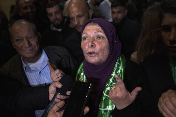 Former Palestinian female prisoner Hanna Barghouti, who was released by the Israeli authorities, talks to the media upon her arrival in the West Bank town of Beitunia, Friday, Nov. 24, 2023. The release came on the first day of a four-day cease-fire deal between Israel and Hamas during which the Gaza militants have pledged to release 50 hostages in exchange for 150 Palestinians imprisoned by Israel. (AP Photo/Nasser Nasser)