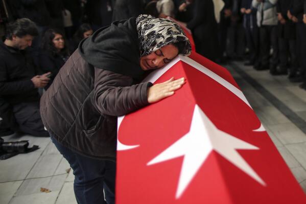 Relatives and friends of Arzu Ozsoy and her 15-year-old daughter Yagmur Ucar, who died in Sunday's explosion occurred on Istiklal avenue, attend their funeral in Istanbul, Turkey, Monday, Nov. 14, 2022. Turkish police said Monday that they have detained a Syrian woman with suspected links to Kurdish militants and that she confessed to planting a bomb that exploded on a bustling pedestrian avenue in Istanbul, killing six people and wounding several dozen others. (AP Photo/Emrah Gurel)