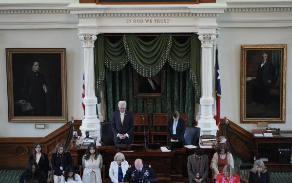 Texas Lt. Gov. Dan Patrick, top left, bows for prayer in the Senate Chamber at the Texas Capitol in Austin, Texas, Monday, May 29, 2023. The historic impeachment of Texas Attorney General Ken Paxton is plunging Republicans into a bruising fight over whether to banish one of their own in America's biggest red state. (AP Photo/Eric Gay)