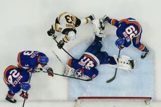 New York Islanders goaltender Semyon Varlamov (40) stops a shot on goal by Boston Bruins' Brad Marchand (63) as teammates Brock Nelson (29), Scott Mayfield (24) and Adam Pelech (3) defend during the first period of Game 4 during an NHL hockey second-round playoff series Saturday, June 5, 2021, in Uniondale, N.Y. (AP Photo/Frank Franklin II)