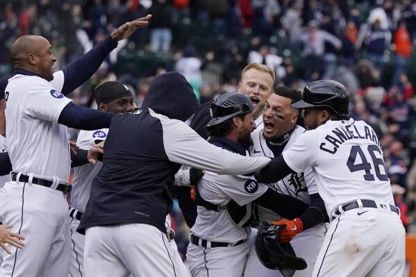 Detroit Tigers' Javier Baez is surrounded by teammates after a walk-off single during the ninth inning of a baseball game against the Chicago White Sox, Friday, April 8, 2022, in Detroit. (AP Photo/Carlos Osorio)