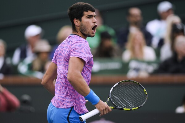 Carlos Alcaraz, of Spain, celebrates after winning a game against Jannik Sinner, of Italy, during a semifinal at the BNP Paribas Open tennis tournament in Indian Wells, Calif., Saturday, March 16, 2024. (AP Photo/Ryan Sun)