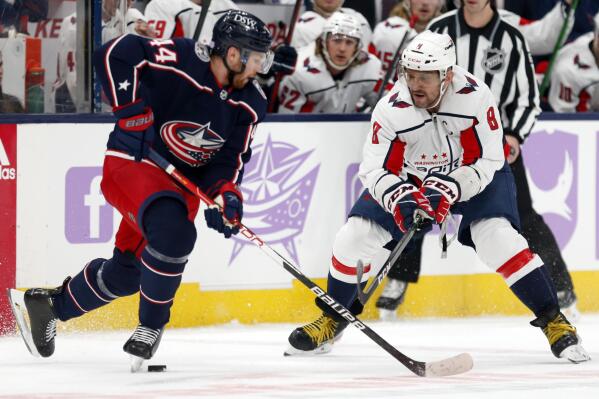 Washington Capitals forward Alex Ovechkin, right, chases the puck in front of Columbus Blue Jackets defenseman Vladislav Gavrikov during the first period of an NHL hockey game in Columbus, Ohio, Friday, Nov. 12, 2021. (AP Photo/Paul Vernon)