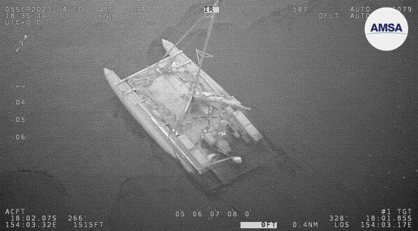 In this photo provided by the Australian Maritime Safety Authority, a partially submerged catamaran is shown during a rescue of 3 sailors in the Coral Sea, Wednesday, Sept. 6, 2023. Three sailors from Russia and France were rescued on Wednesday after the inflatable catamaran they were trying to navigate from Vanuatu to Australia came under attack from sharks, authorities said. (Australian Maritime Safety Authority via AP)