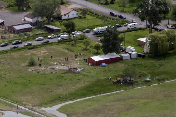 In this aerial photo, investigators search for human remains at Chad Daybell's residence in the 200 block of 1900 East, Tuesday, June 9, 2020, in Salem, Idaho. Authorities say they uncovered human remains at Daybell's home as they investigated the disappearance of his new wife’s two children. Police in the small town of Rexburg say Daybell was taken into custody Tuesday. He had recently married the children’s mother, Lori Vallow Daybell, who has been charged with child abandonment. (John Roark/The Idaho Post-Register via AP)