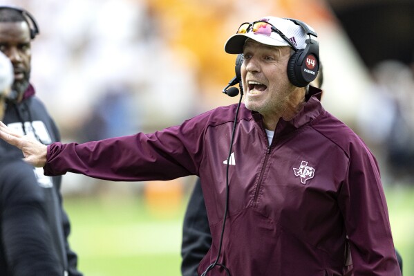 Texas A&M head coach Jimbo Fisher yells at his players during the second half of an NCAA college football game against Tennessee, Saturday, Oct. 14, 2023, in Knoxville, Tenn. (AP Photo/Wade Payne)