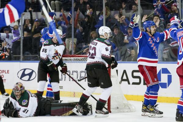 New York Rangers left wing Chris Kreider, right, and dArizona Coyotes goaltender Scott Wedgewood (31) react after Kreider scored his third goal of the night, during the third period of an NHL hockey game Saturday, Jan. 22, 2022, at Madison Square Garden in New York. The Rangers won 7-3. (AP Photo/Mary Altaffer)