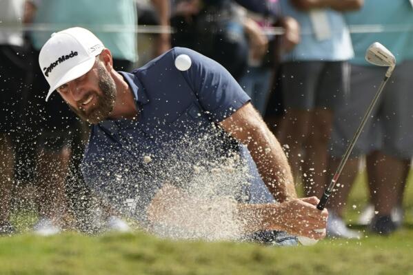 Dustin Johnson hits from a bunker on the third hole during the second round of the LIV Golf Team Championship at Trump National Doral Golf Club, Saturday, Oct. 29, 2022, in Doral, Fla. (AP Photo/Lynne Sladky)