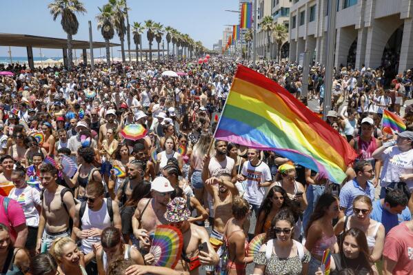 People participate in the annual Pride Parade, in Tel Aviv, Israel, Friday, June 25, 2021. Tens of thousands of people attended the parade on Friday in one of the largest public gatherings held in Israel since the onset of the coronavirus pandemic. (AP Photo/Ariel Schalit)