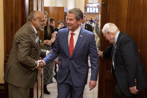 FILE - Georgia Gov. Brian Kemp enters to address the House of Representatives, March 28, 2024, at the state Capitol in Atlanta. Kemp on Thursday, April 18, signed a package of income tax cuts, as well as a bill that could cap the increase in a home's taxable value if voters approve in November. (Arvin Temkar/Atlanta Journal-Constitution via AP, File)