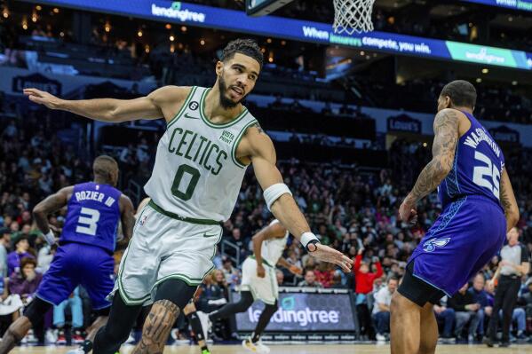 Boston Celtics forward Jayson Tatum (0) celebrates after a dunk against the Charlotte Hornets during the second half of an NBA basketball game on Saturday, Jan. 14, 2023, in Charlotte, N.C. (AP Photo/Scott Kinser)