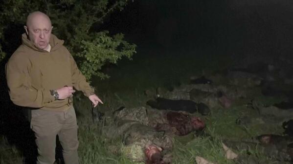 In this handout image taken from a video released by Prigozhin Press Service on Friday, May 5, 2023, head of Wagner Group Yevgeny Prigozhin stands in front of multiple bodies lying on the ground in an unknown location. The owner of Russia's private military company Wagner, Yevgeny Prigozhin, on Friday threatened to pull out Wagner forces from the embattled Ukrainian city of Bakhmut next week, accusing Russia's military command of starving the group of ammunition. (Prigozhin Press Service via AP)