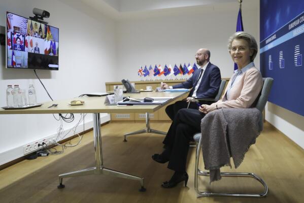 European Commission President Ursula von der Leyen, right, and European Council President Charles Michel prepare to take part in an online meeting of G7 leaders at the European Council building in Brussels, Friday, Feb. 19, 2021. (Olivier Hoslet, Pool via AP)
