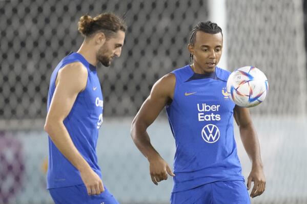 France's Adrien Rabiot, left, and Jules Kounde juggle during a training session at the Jassim Bin Hamad stadium in Doha, Qatar, Saturday, Nov. 19, 2022. France will play their first match in the World Cup against Australia on Nov. 22. (AP Photo/Christophe Ena)