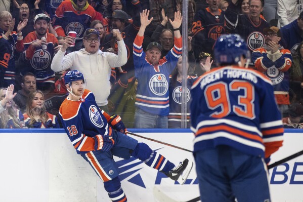 Edmonton Oilers' Zach Hyman (18) and Ryan Nugent-Hopkins (93) celebrate a goal against the Washington Capitals during the second period of an NHL hockey game Wednesday, March 13, 2024, in Edmonton, Alberta. (Jason Franson/The Canadian Press via AP)