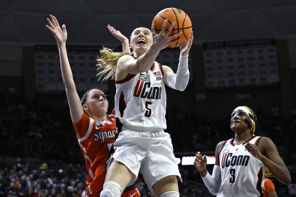 UConn guard Paige Bueckers (5) shoots as Syracuse guard Georgia Woolley, left, defends in the second half of a second-round college basketball game in the NCAA Tournament, Monday, March 25, 2024, in Storrs, Conn. (AP Photo/Jessica Hill)