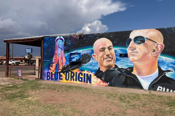 The side of a building in Van Horn, Texas, is adorned with a mural of Blue Origin founder Jeff Bezos on Saturday, July 17, 2021, just days before Bezos plans to launch into space from the Blue Origin spaceport about 25 miles outside of the West Texas town. (AP Photo/Sean Murphy)