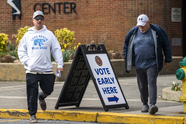 People exit a voting center during early voting in the states' presidential primary election, Tuesday, March 26, 2024, in Freeport, N.Y. In Long Island's Nassau County, a handful of Latino residents and a local civil rights organization allege that a redistricting map drawn by the county Legislature dilutes the voting power of Black, Latino and Asian residents. (AP Photo/Eduardo Munoz Alvarez)