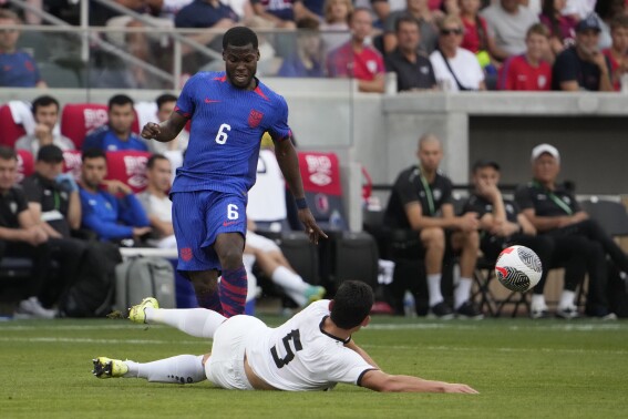 Uzbekistan's Rustam Ashurmatov (5) and United States' Yunus Musah (6) battle for the ball during the second half of an international friendly soccer match Saturday, Sept. 9, 2023, in St. Louis. (AP Photo/Jeff Roberson)