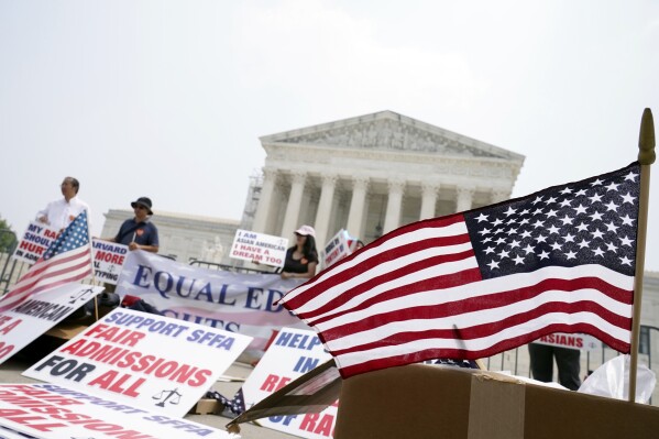 People protest outside of the Supreme Court in Washington, Thursday, June 29, 2023. The Supreme Court on Thursday struck down affirmative action in college admissions, declaring race cannot be a factor and forcing institutions of higher education to look for new ways to achieve diverse student bodies. (AP Photo/Mariam Zuhaib)