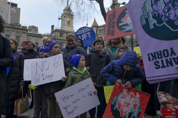 A small group of students, parents, and immigrant advocates rally near City Hall in New York, Tuesday, Dec. 19, 2023. The rally was held in response to an order New York Mayor Eric Adams issued in October limiting homeless migrants and their children to 60 days in city housing. (AP Photo/Seth Wenig)