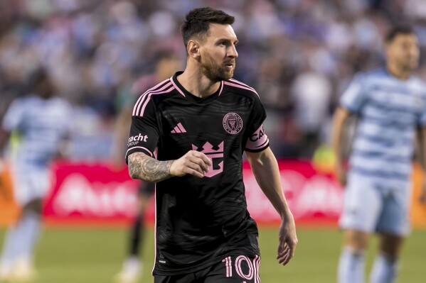Inter Miami forward Lionel Messi (10) jogs to his position during the first half of an MLS soccer match against Sporting Kansas City, Saturday, April 13, 2024, in Kansas City, Mo. (AP Photo/Nick Tre. Smith)