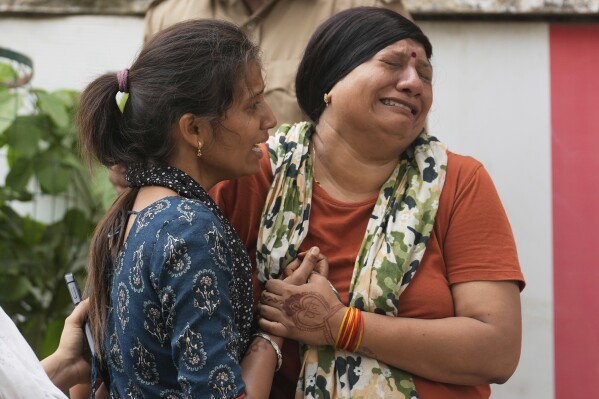 On Friday, June 13, 2025, a relative of the grieving of the victim of the crash accident on Air India plane outside the autopsy room at a hospital in Ahmedabad, India.