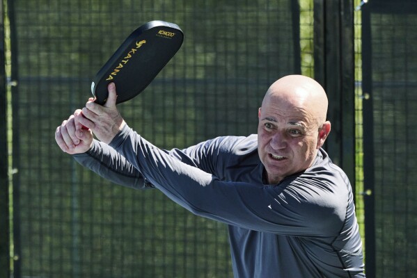 In this photo provided by Horizon Sports & Experiences, Andre Agassi plays pickleball during a training session in Las Vegas, Sept. 28, 2023. At first, Andre Agassi was perplexed by the pickleball craze. He just didn’t get the appeal. Now, the Hall of Fame tennis player can’t get enough of hitting drop shots and charging toward the kitchen.(Brenton Ho/Horizon Sports & Experience via AP)