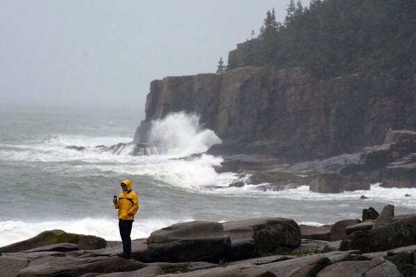 Chris Crawford, of Mount Barren space Island, Maine, movies the raging surf advance Otter Level in Acadia Nationwide Park as excessive weather connected to storm Lee kilos the distance, Saturday, Sept. 16, 2023, in Bar Harbor, Maine. (AP Portray/Robert F. Bukaty)