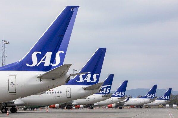 FILE - SAS planes are grounded at Oslo Gardermoen airport, in Oslo, on April 26, 2019. An international flight Wednesday, Feb. 14, 2024, hit a fence at the Oslo airport, causing minor damage to the aircraft and no injuries, in the third mishap in two weeks in which aircraft are being pulled away from gates at Norway's main airport. (Ole Berg-Rusten/NTB Scanpix via AP, File)