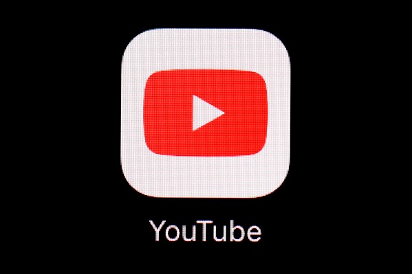 FILE - The YouTube app is displayed on an iPad in Baltimore. YouTube has blocked access to videos of a protest song in Hong Kong, days after court approved an injunction banning the song in the city. (AP Photo/Patrick Semansky, File)