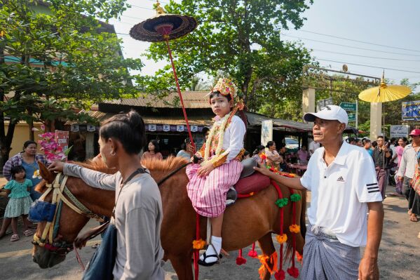 A boy who is to become Buddhist novice rides on horse during a procession parade as part of a celebration of a novitiation or “Shinbyu,” ceremony, Saturday, March 15, 2025, at Hlegu township, outside of Yangon, Myanmar. (AP Photo/Thein Zaw)