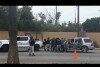 In this image made from video, Mexican security forces frisk men at a checkpoint in Ensenada, Mexico, Thursday, May 2, 2024. Mexican authorities said Thursday they have found tents and questioned a few people in the case of two Australians and an American who went missing over the weekend in the Pacific coast state of Baja California. (AP Photo)