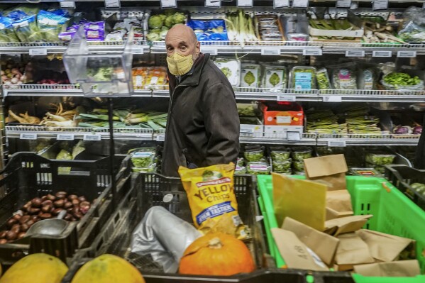 Joe Holtz, co-founder and general manager at Brooklyn's Park Slope Co-Op grocery store, walks the store's isles where a policy requires shoppers to mask-up Wednesdays and Thursdays, Thursday, Dec. 7, 2023, in New York. (AP Photo/Bebeto Matthews)